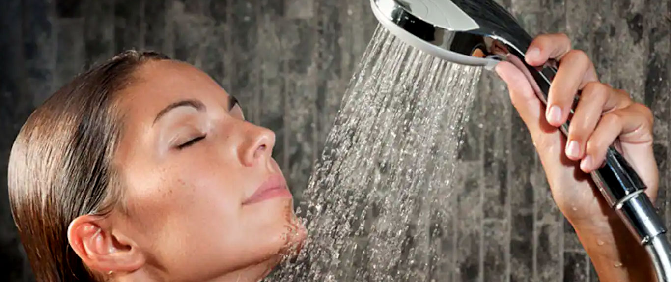 Woman enjoying a well-functioning shower system installed by Northern Brisbane plumbing specialists